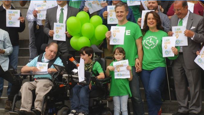 Cora True-Frost with her family at World Cerebral Palsy Day celebration in Syracuse city hall.